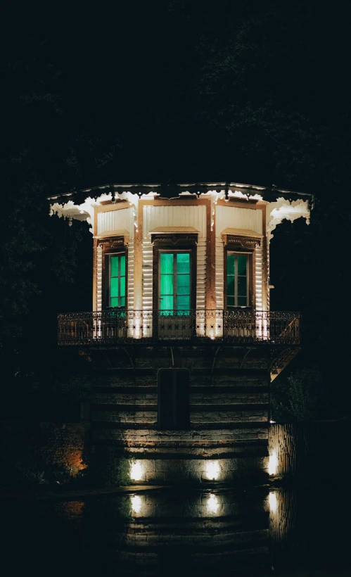 an illuminated building in the dark by night