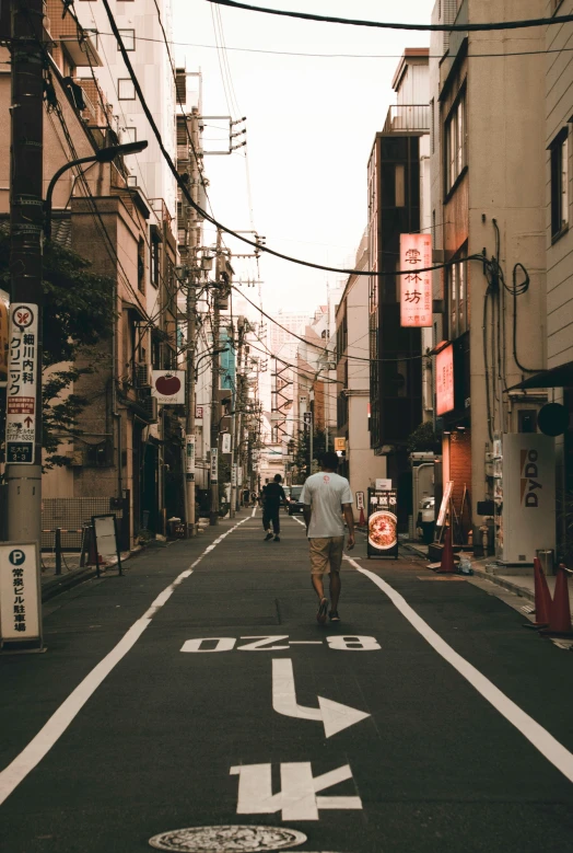 a person riding a skateboard on a narrow street