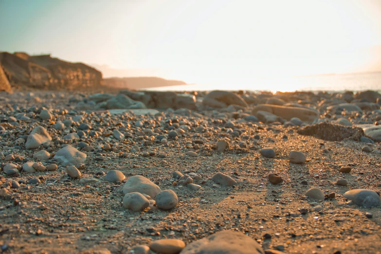 a close up of rocks on a beach near the ocean