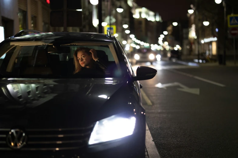 a woman sitting in the drivers seat of a car