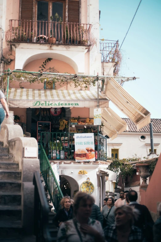 people walking on some stairs near a building