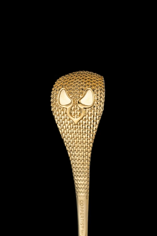 a gold trophy that has an angry face on it