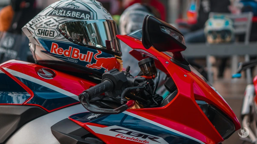 a red motorcycle with a helmet on the back of it