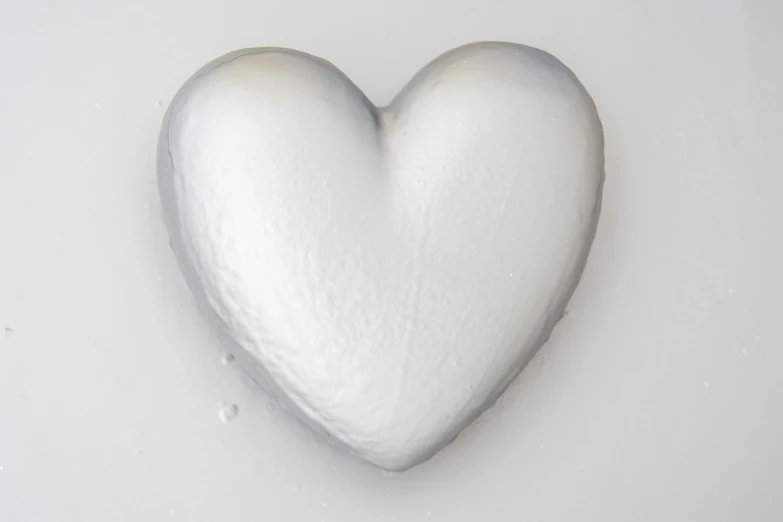 a white heart shaped candy sitting on top of a counter