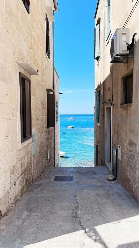 an empty street with water in between two buildings