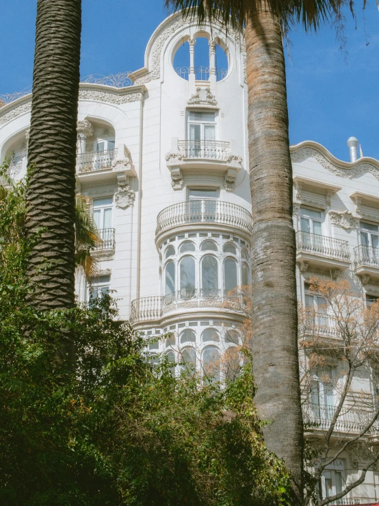 a big white building next to some trees