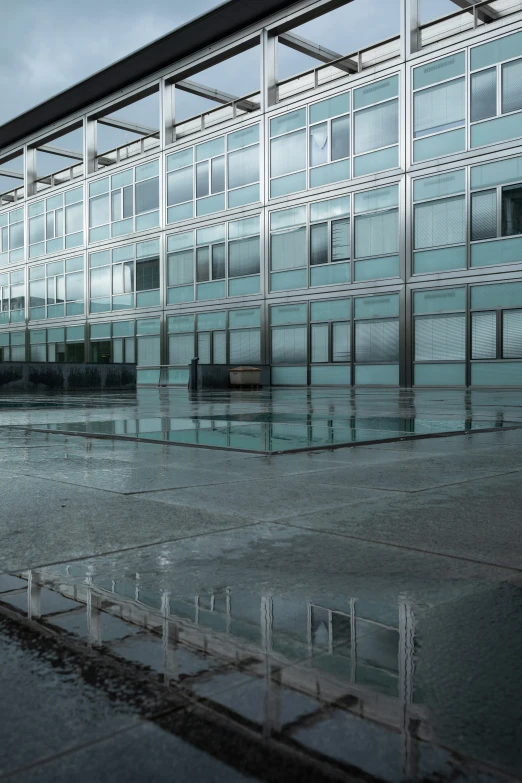 a large glass building with a few raindrops on it