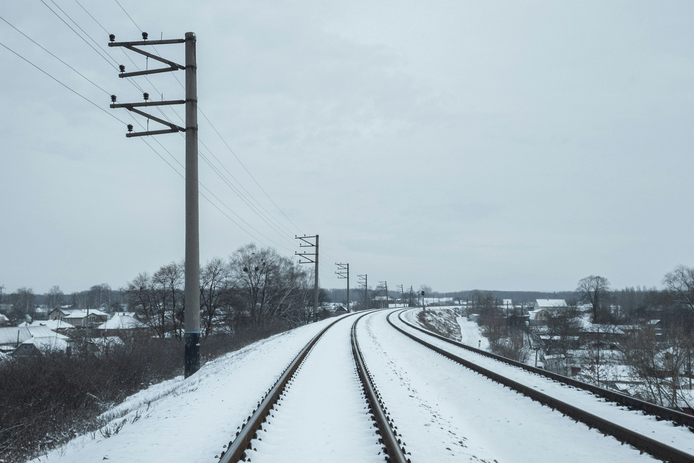 the railroad track in winter is snow covered