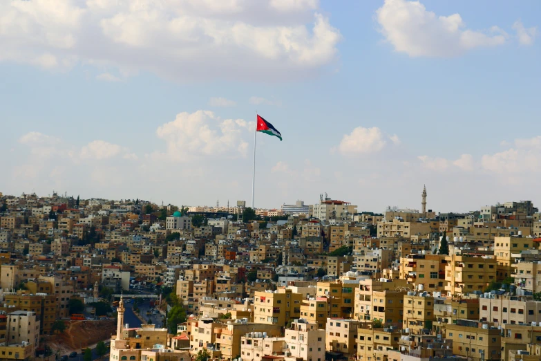 a kite is flying high over a large city