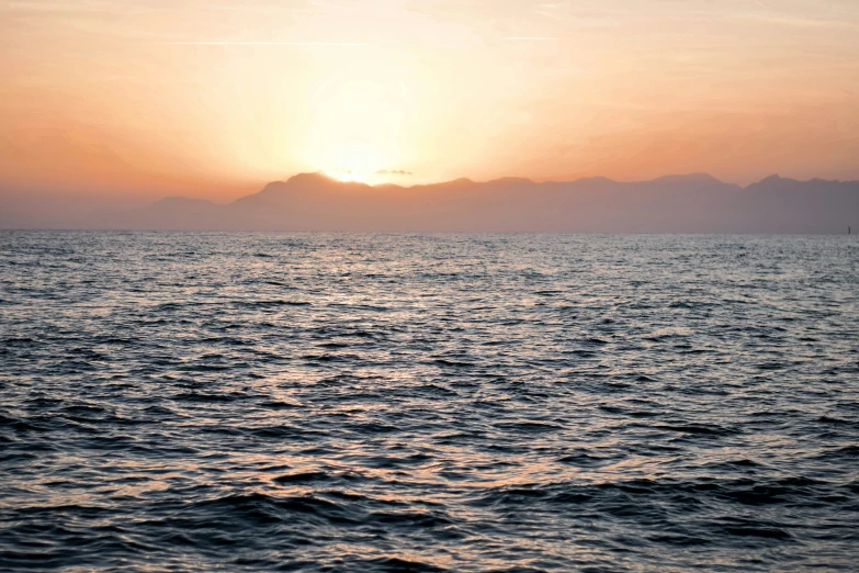 a po taken from the ocean with mountains in the background