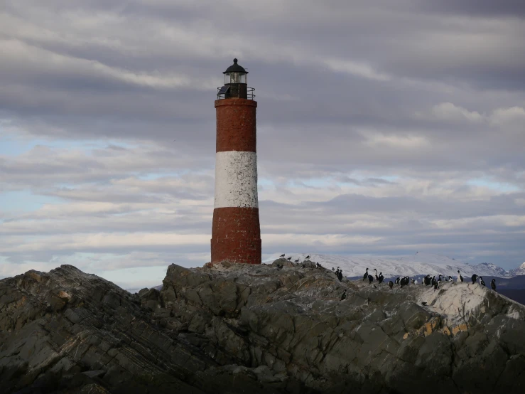 a large stone pillar with a lighthouse sitting on top