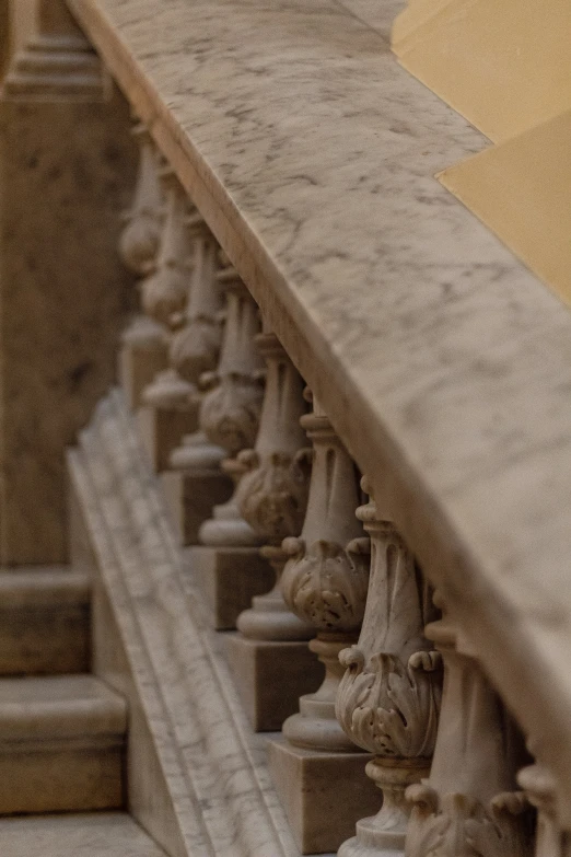 a stair is on a concrete wall with multiple ornamental statues