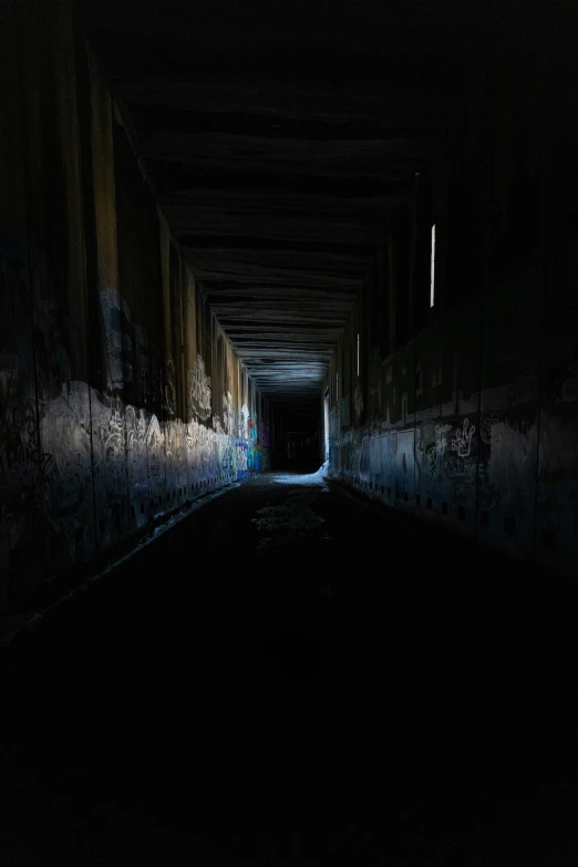 dark and dirty tunnel with several colors and lights at night