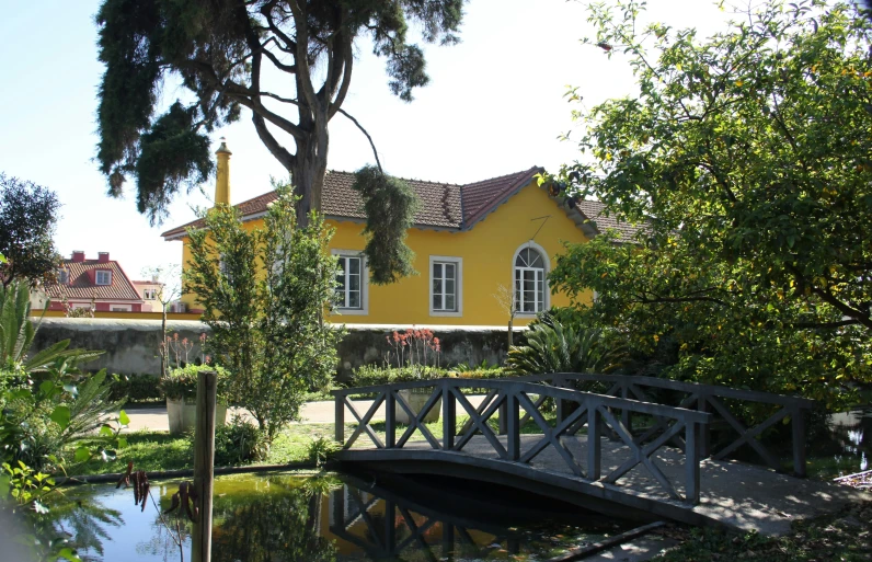 a bridge crossing the water towards the houses