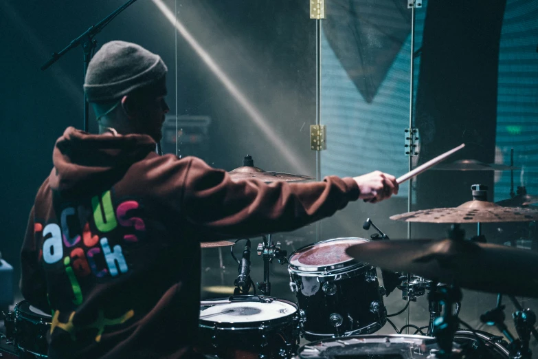 a drummer holds his drums in front of him