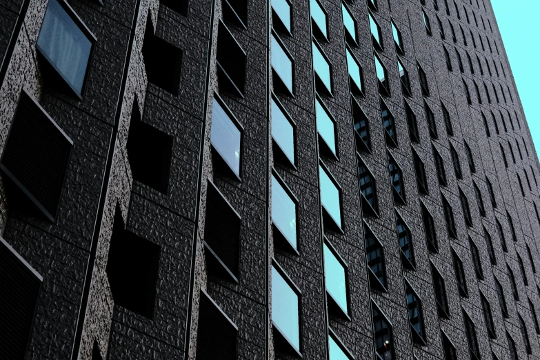 a tall building with many windows next to another tall building