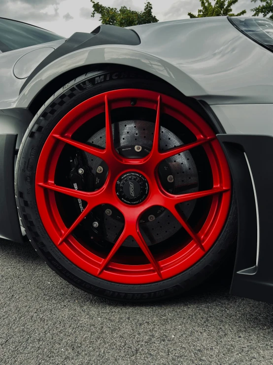 the front wheel of a gray sports car