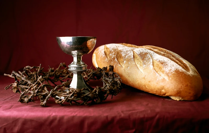 an object made out of bread and a silver cup