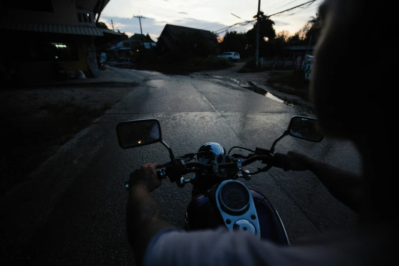 a view looking down the road at someone riding a motorcycle