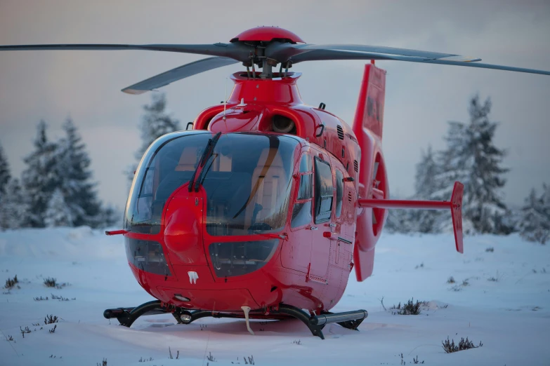 the side of a helicopter parked in the snow