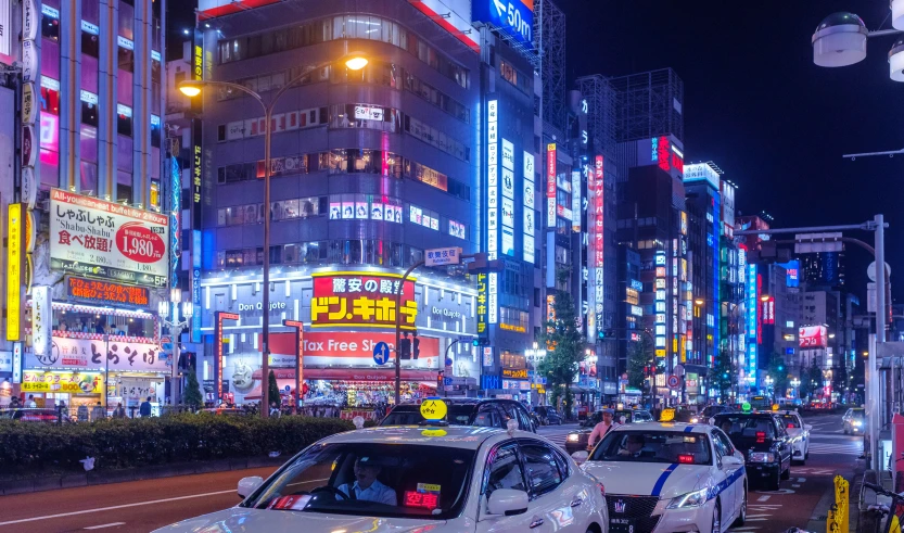 cars at a busy city intersection at night