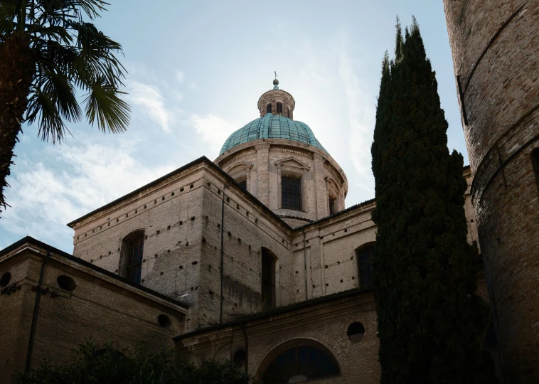 the dome of a church is visible through the trees