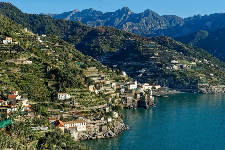 a village sitting on the side of a body of water