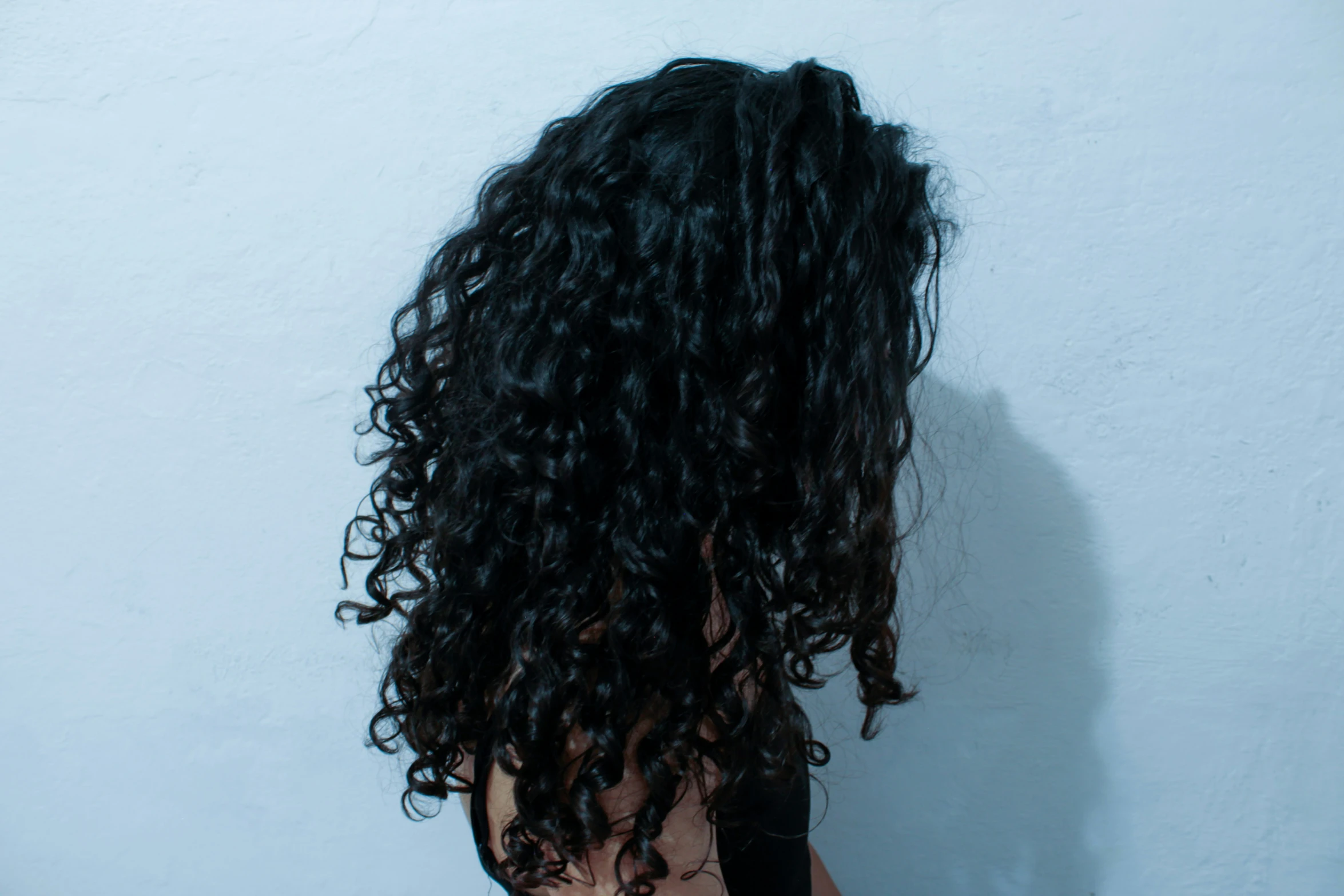 the back of a woman's head with wavy hair