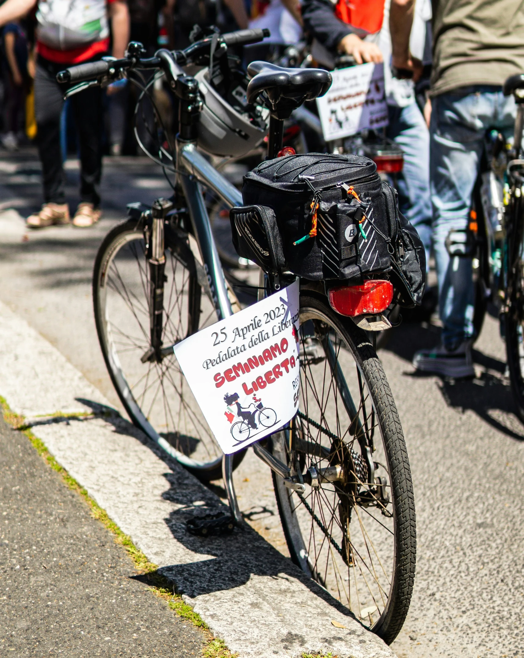 people on a city street lined up with their bicycles