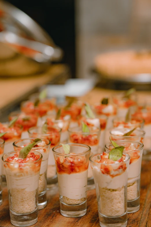 a row of small cups filled with food