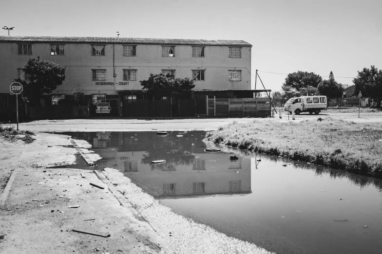 a large building next to water and trees