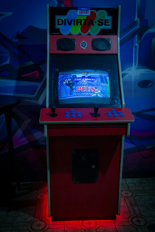 an old - fashioned arcade machine with colorful light reflecting off the side