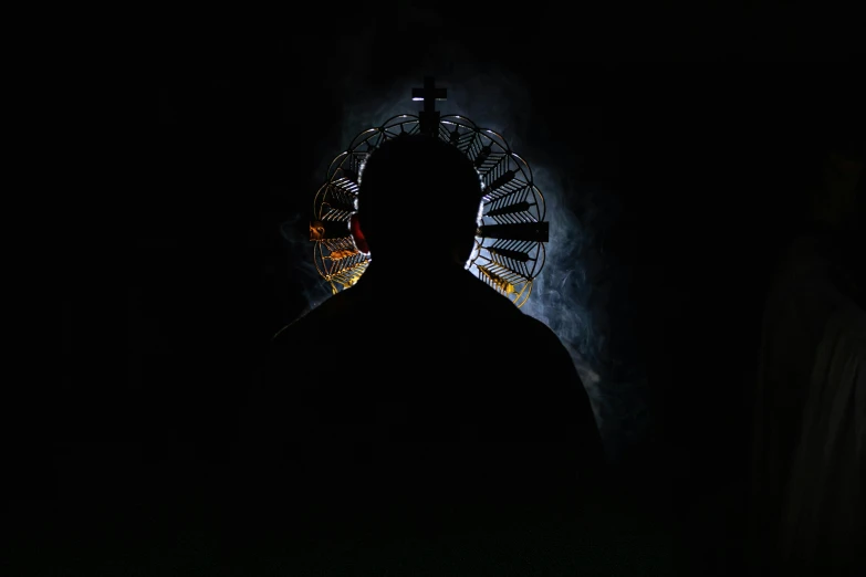 a man is standing in the dark with a dark background