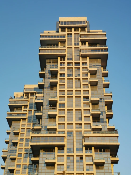 this tall building has balconies on the windows