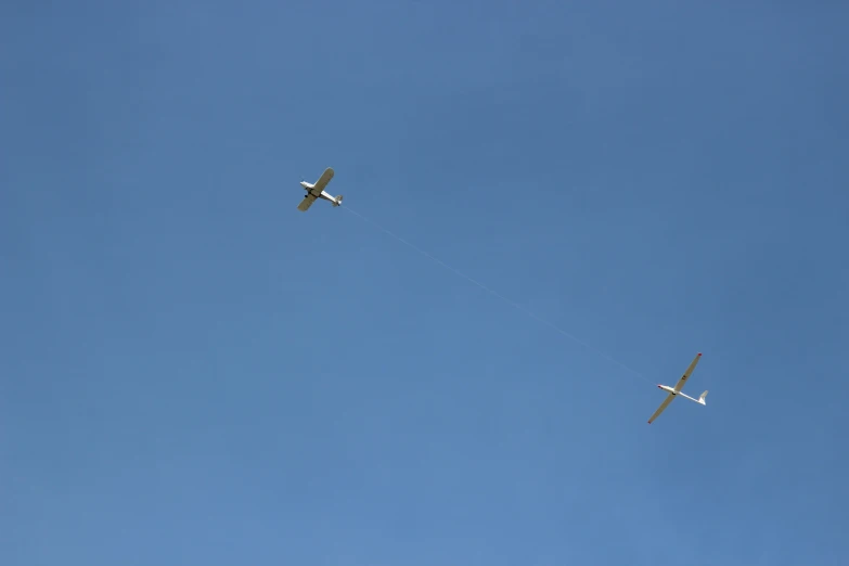 two airplanes are flying in the blue sky