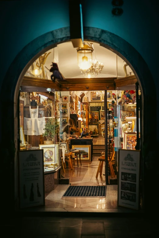 a very pretty store front with its windows illuminated by some lights