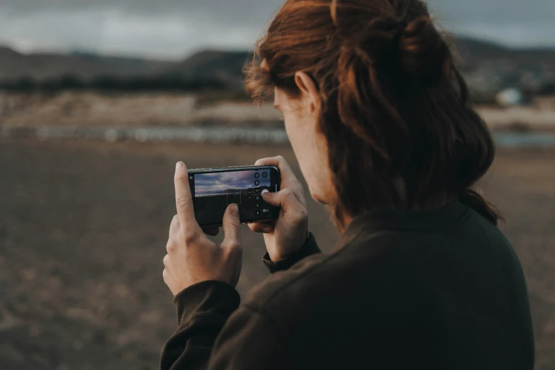 a woman taking a po with her camera phone