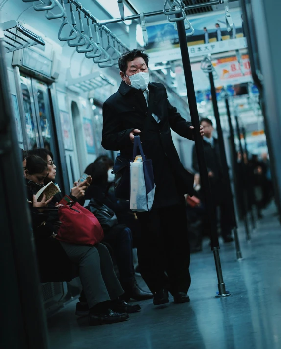 a man standing on the subway in a mask