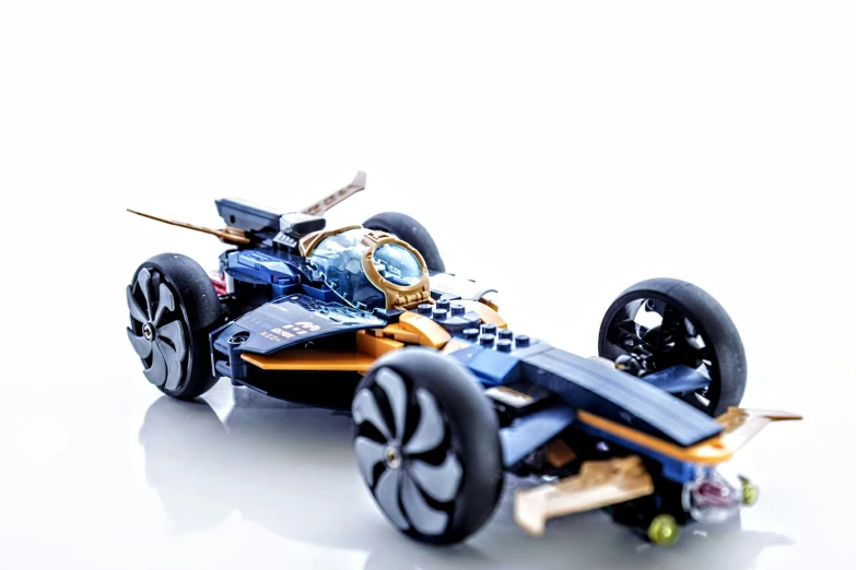 a toy car with wheels that are black and gold