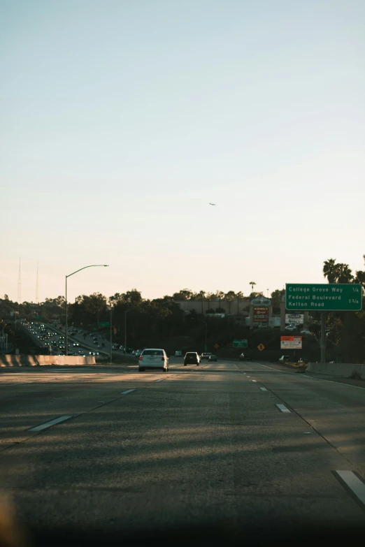 a highway with a sky background and street sign