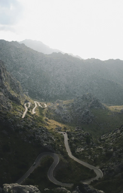 a winding road going up in a mountainside