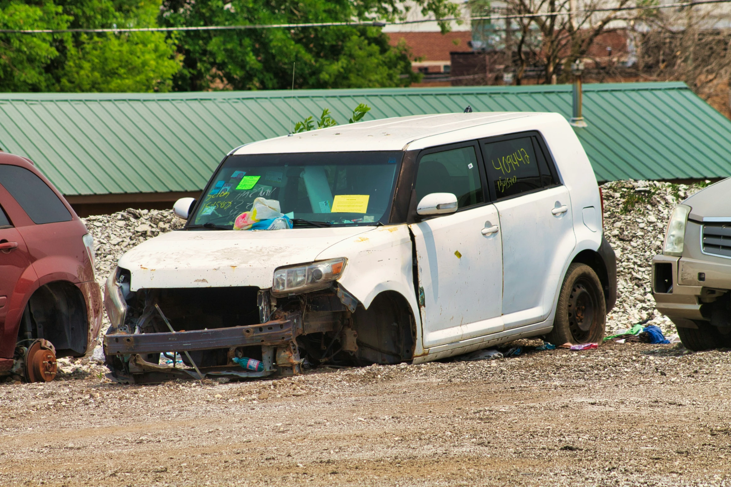 three cars that have been wrecked on the side of the road