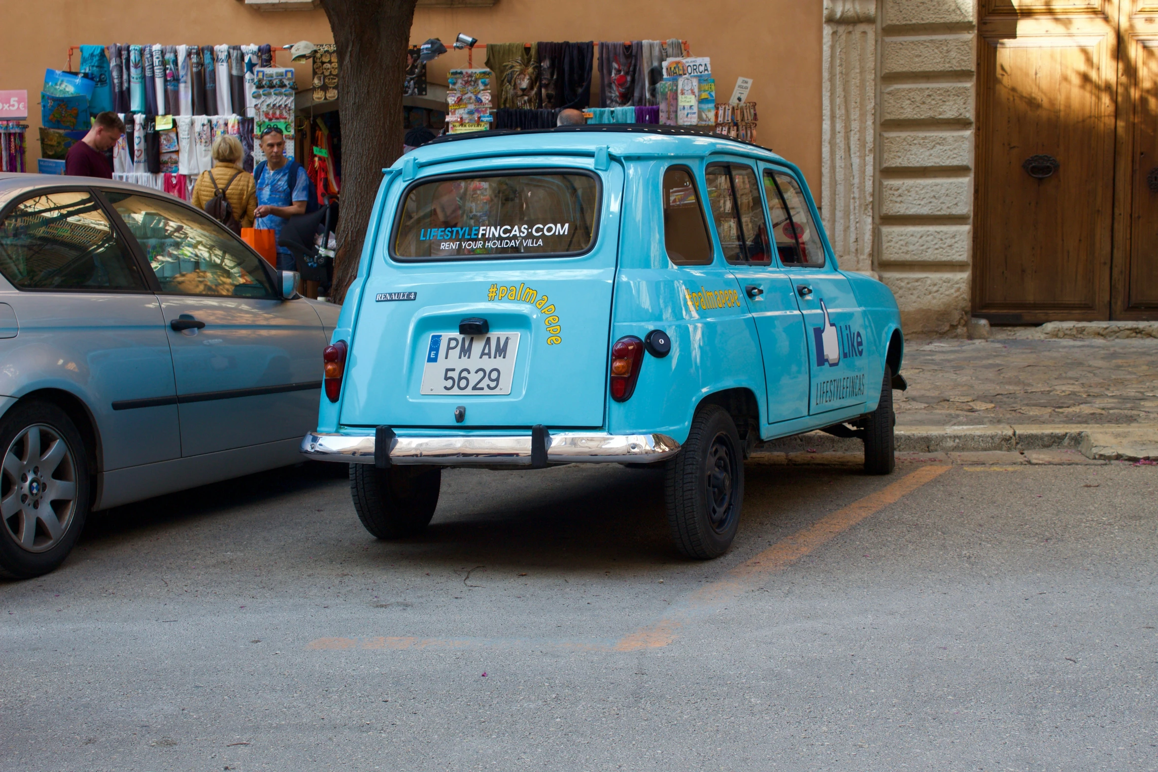 an old blue vehicle on the side of the road