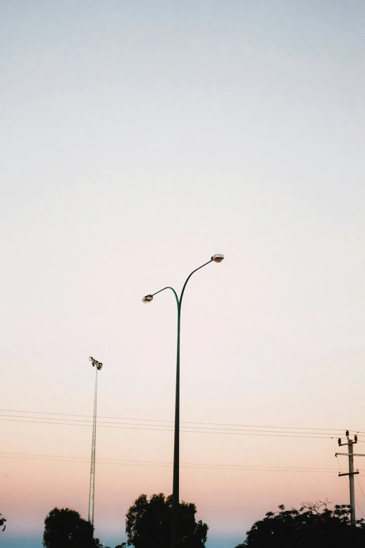 an empty lot is lit up by street lights