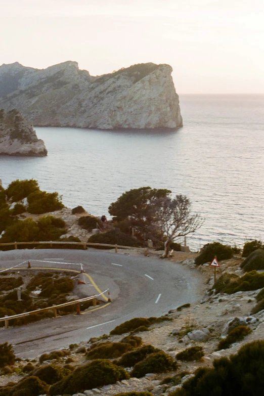 two people riding bicycles on an open mountain road