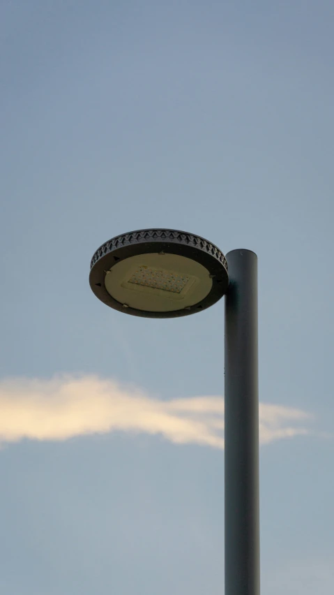 a street light in front of a blue sky