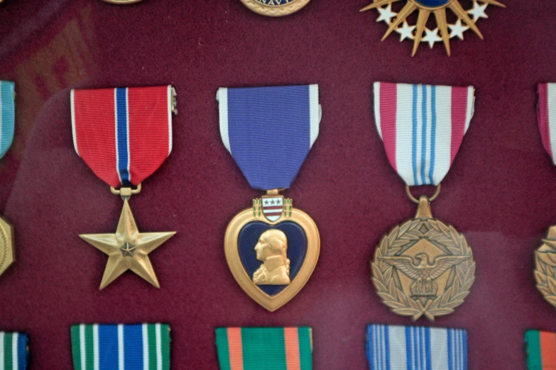 an assortment of medals on display for public use
