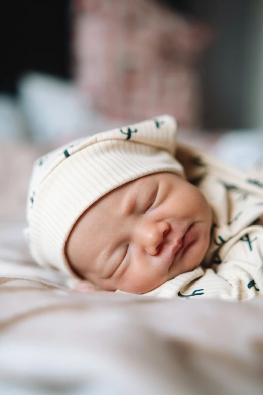 a baby is sleeping on top of a blanket