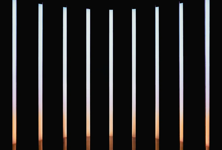 five poles are arranged against the black background