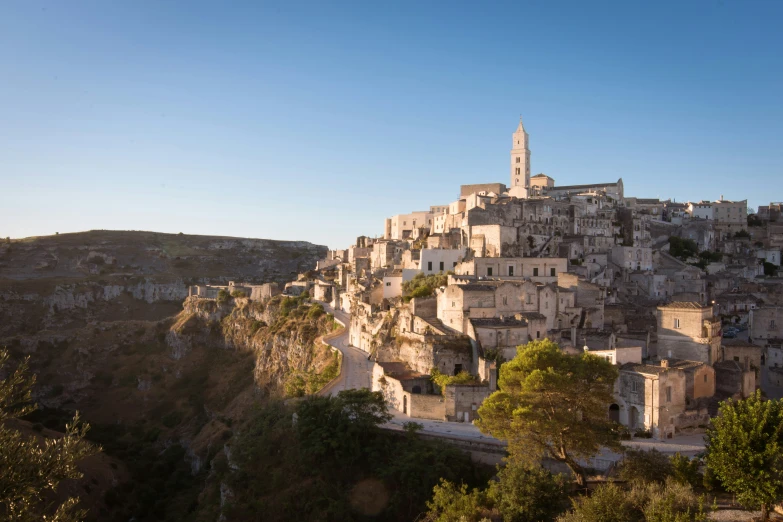 a town perched atop a cliff side in the countryside